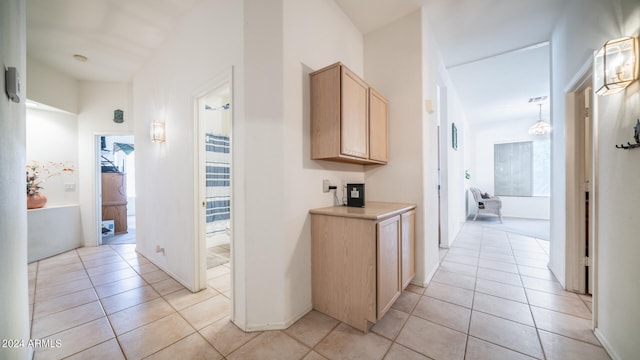 corridor with light tile patterned flooring