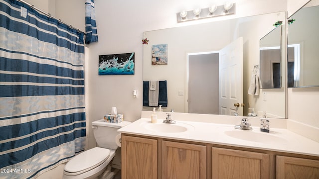 bathroom with a shower with curtain, vanity, and toilet