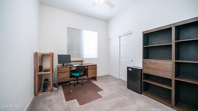 carpeted office space with ceiling fan