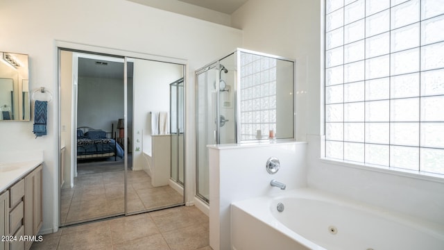 bathroom with tile patterned floors, vanity, and separate shower and tub