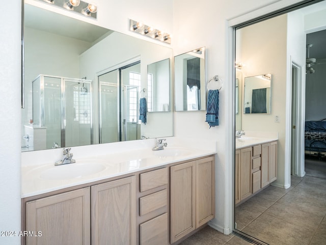 bathroom with tile patterned floors, vanity, and walk in shower