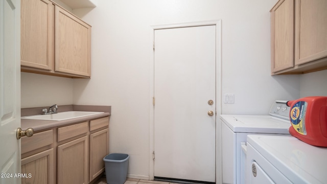 laundry room featuring separate washer and dryer, sink, light tile patterned flooring, and cabinets