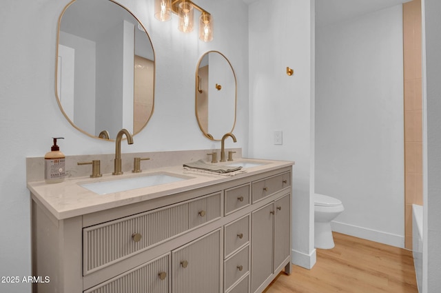 2712 N 20th Dr, Phoenix, AZ 85009 - bathroom featuring double vanity, wood finished floors, and a tub