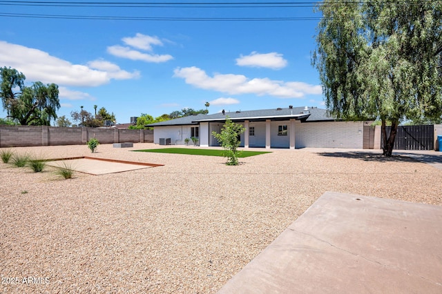 2712 N 20th Dr, Phoenix, AZ 85009 - back of house with a fenced backyard, a patio area, and brick siding
