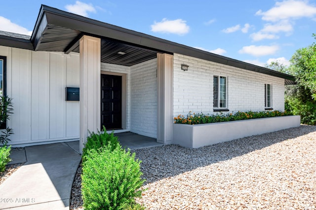 2712 N 20th Dr, Phoenix, AZ 85009 - property entrance featuring board and batten siding and brick siding