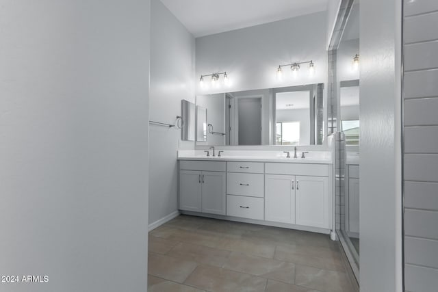 bathroom with dual vanity and tile patterned floors