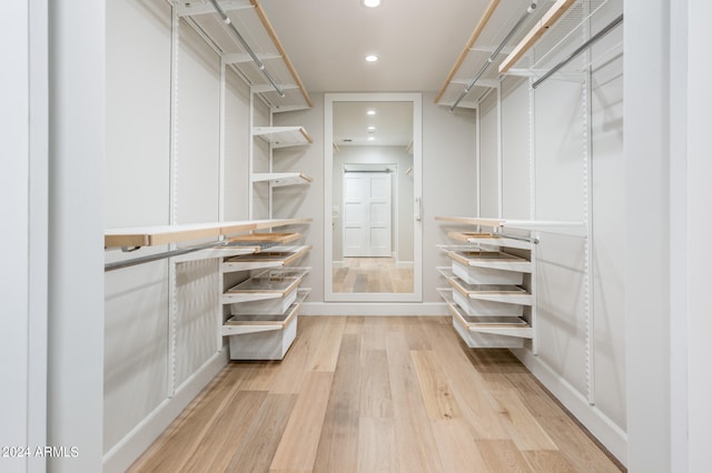 spacious closet featuring light hardwood / wood-style flooring