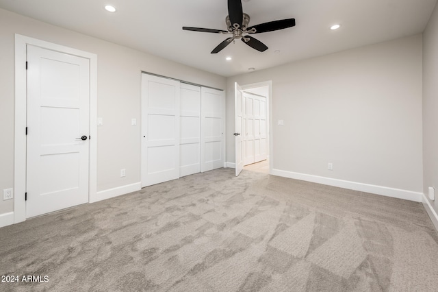 unfurnished bedroom featuring ceiling fan and light colored carpet