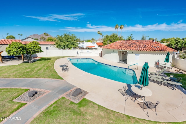 view of swimming pool featuring a lawn and a patio area