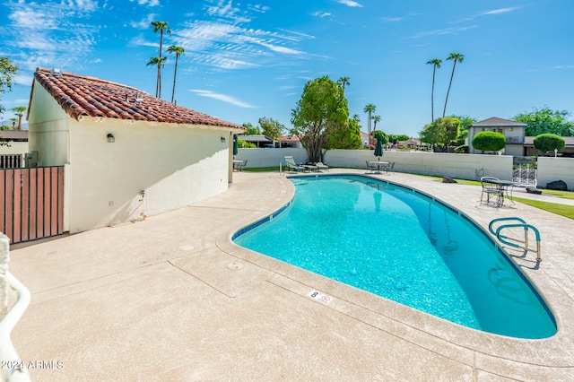 view of swimming pool with a patio area