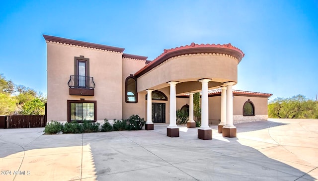 mediterranean / spanish house with a patio and a balcony