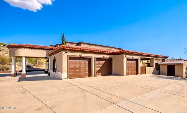 mediterranean / spanish home with a garage