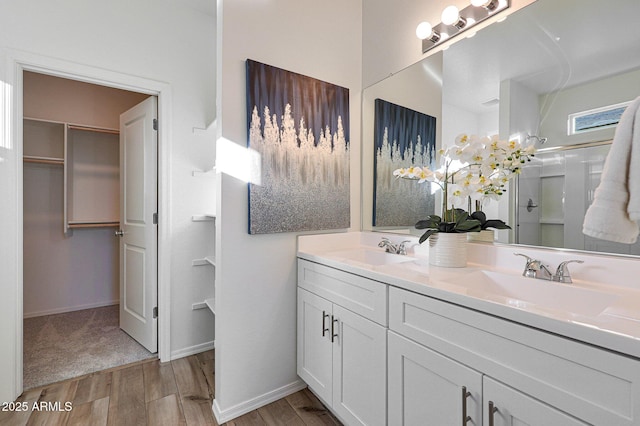 18052 W Sand Hills Rd, Surprise, AZ 85387 - full bathroom with double vanity, wood finished floors, a shower, and a sink