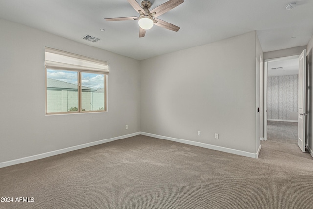 empty room with ceiling fan and light colored carpet