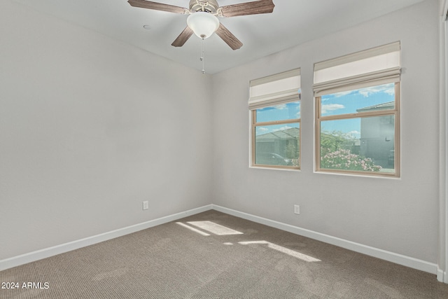 carpeted empty room featuring ceiling fan