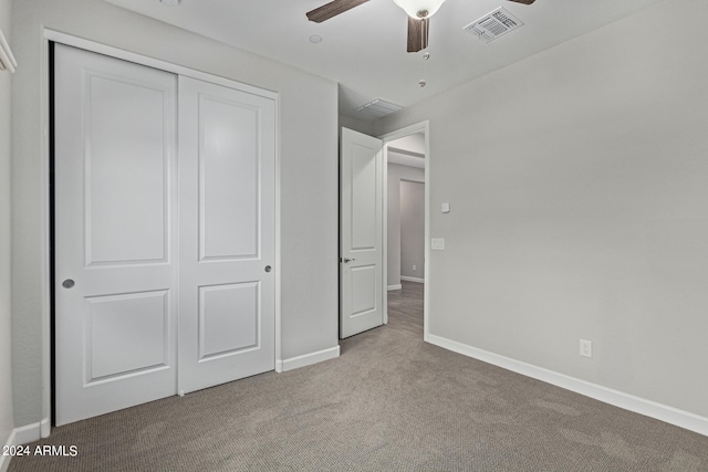 unfurnished bedroom featuring a closet, ceiling fan, and light colored carpet