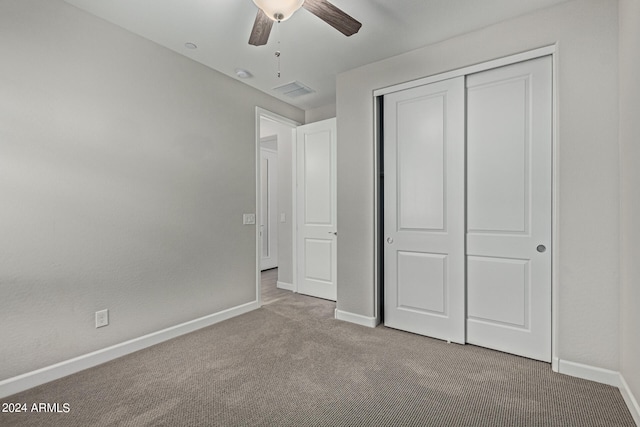 unfurnished bedroom featuring a closet, ceiling fan, and dark carpet