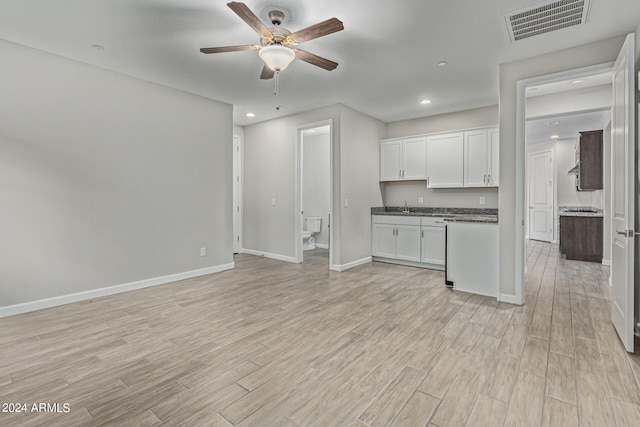 unfurnished living room featuring ceiling fan and light hardwood / wood-style floors