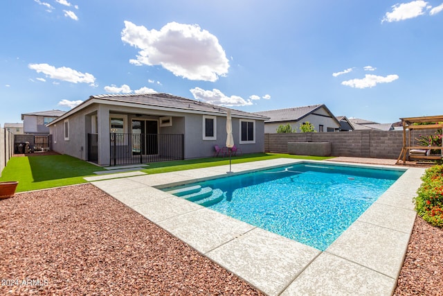 view of pool featuring a yard