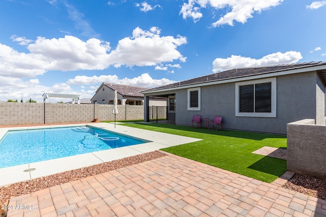 view of swimming pool with a yard and a patio