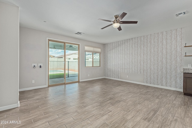 spare room featuring ceiling fan and light hardwood / wood-style flooring