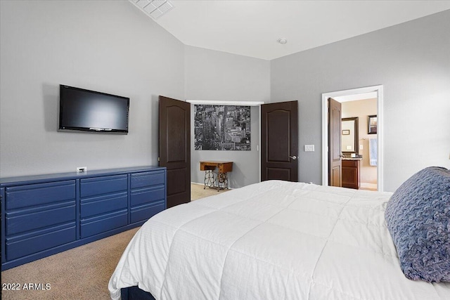 bedroom with light colored carpet, connected bathroom, and vaulted ceiling