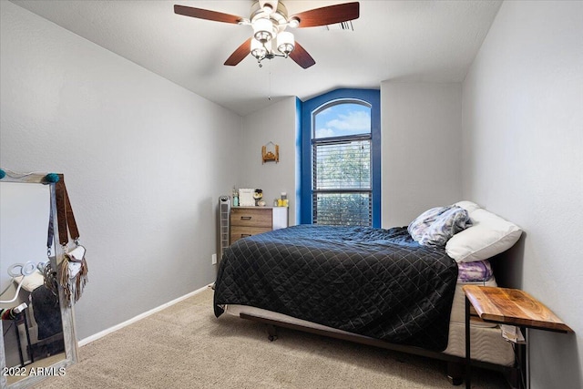 bedroom featuring ceiling fan, carpet flooring, and lofted ceiling