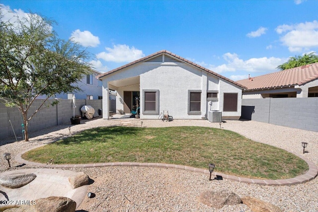 back of house with a patio, central AC, and a lawn