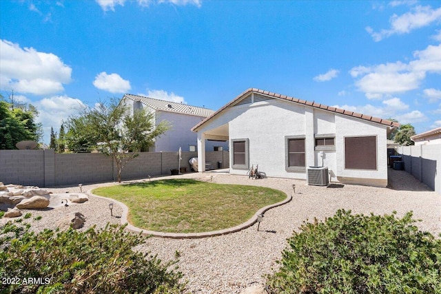 back of property with a patio and a yard