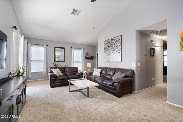 carpeted living room featuring lofted ceiling