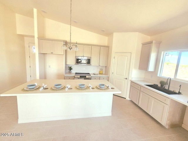 38167 W San Juan Ave, Tonopah, AZ 85354 - kitchen featuring stainless steel appliances, a sink, a kitchen island, light countertops, and hanging light fixtures