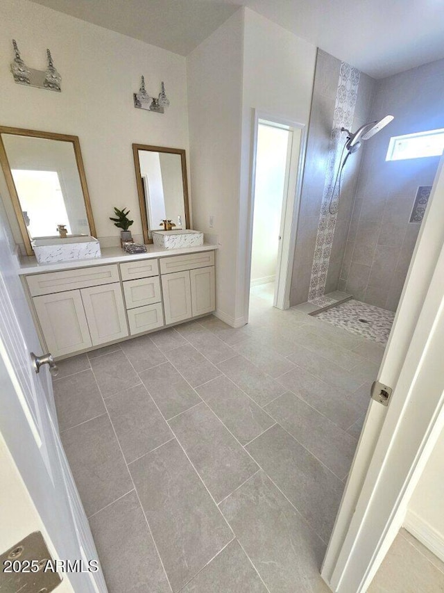 38167 W San Juan Ave, Tonopah, AZ 85354 - bathroom featuring a tile shower, double vanity, and tile patterned flooring