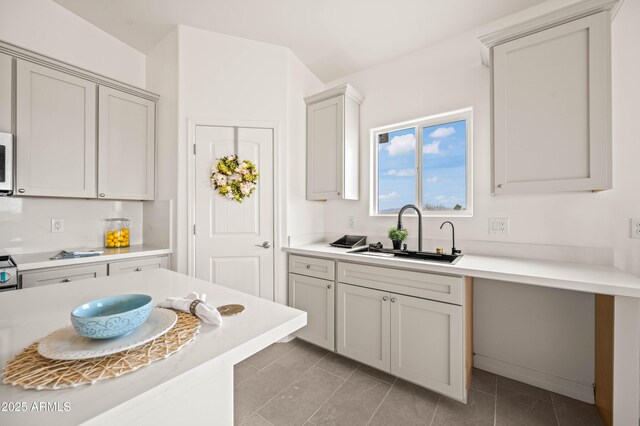 38167 W San Juan Ave, Tonopah, AZ 85354 - kitchen with a sink, light countertops, white microwave, and light tile patterned floors