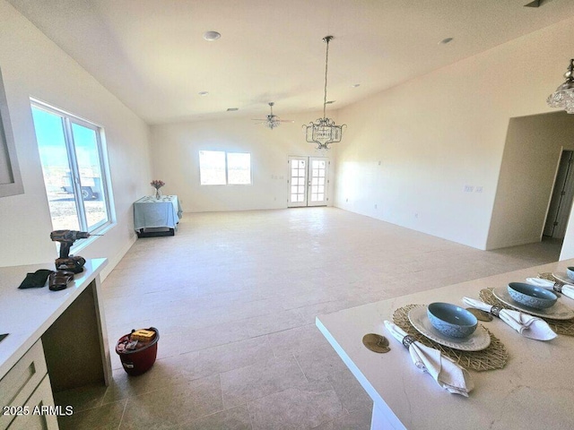 38167 W San Juan Ave, Tonopah, AZ 85354 - unfurnished dining area featuring lofted ceiling, ceiling fan, and a chandelier