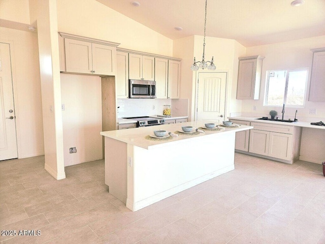 38167 W San Juan Ave, Tonopah, AZ 85354 - kitchen with stainless steel appliances, a sink, light countertops, a center island, and a chandelier