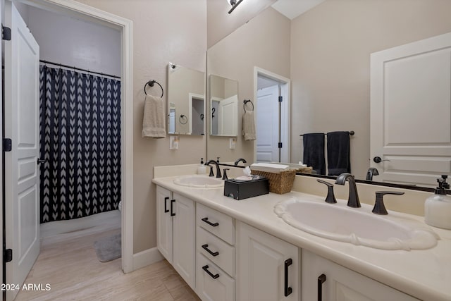 bathroom featuring vanity, a shower with shower curtain, and hardwood / wood-style flooring