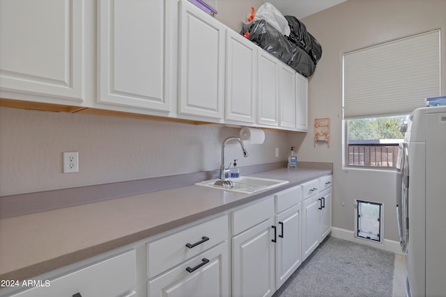 kitchen featuring white cabinets, white fridge, washer / clothes dryer, and sink