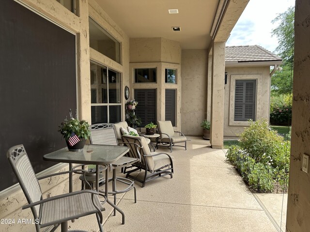 view of patio with a swimming pool with hot tub