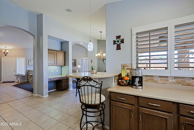 5049 E Duane Ln, Cave Creek, AZ 85331 - kitchen with light countertops, arched walkways, an inviting chandelier, and light tile patterned flooring