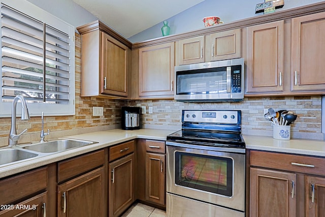 5049 E Duane Ln, Cave Creek, AZ 85331 - kitchen with decorative backsplash, vaulted ceiling, light countertops, a sink, and stainless steel appliances