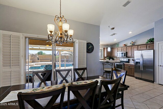5049 E Duane Ln, Cave Creek, AZ 85331 - dining room featuring an inviting chandelier, vaulted ceiling, light tile patterned flooring, and a healthy amount of sunlight
