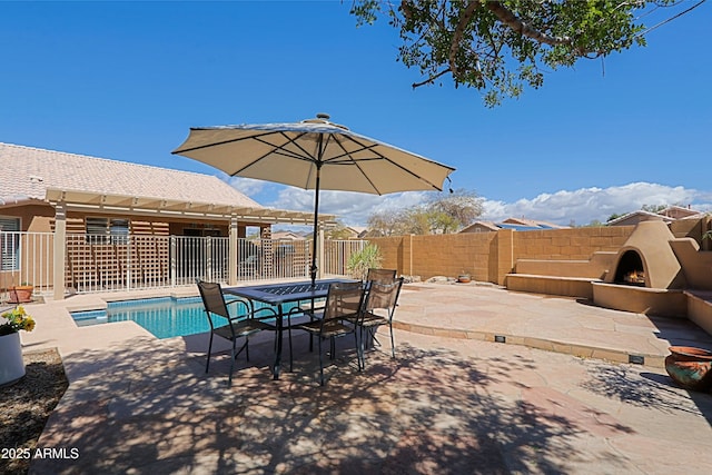 5049 E Duane Ln, Cave Creek, AZ 85331 - view of patio / terrace with fence, a warm lit fireplace, and a fenced in pool
