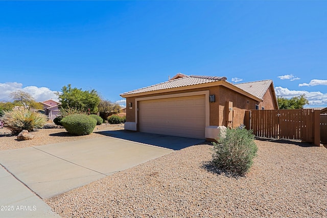 5049 E Duane Ln, Cave Creek, AZ 85331 - exterior space with an attached garage, stucco siding, concrete driveway, and a tiled roof
