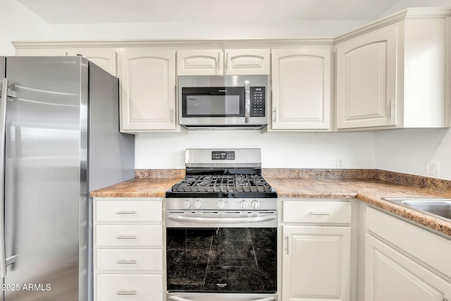 508 S Pasadena, Mesa, AZ 85210 - kitchen with appliances with stainless steel finishes, light countertops, and white cabinetry