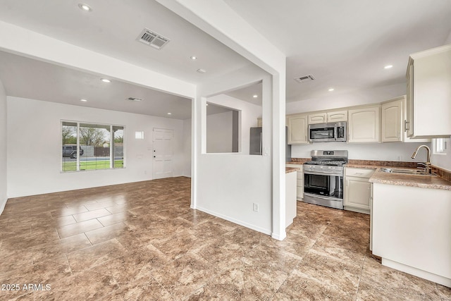 508 S Pasadena, Mesa, AZ 85210 - kitchen with appliances with stainless steel finishes, a sink, open floor plan, recessed lighting, and light countertops