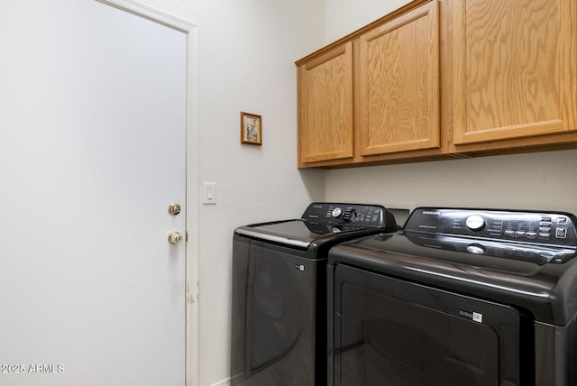 washroom with cabinet space and separate washer and dryer