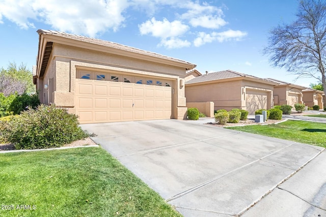 view of front of home with concrete driveway, a front lawn, and stucco siding