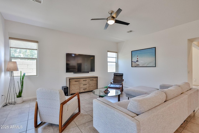 17082 S 182nd Ave, Goodyear, AZ 85338 - living area featuring healthy amount of natural light, light tile patterned flooring, and a ceiling fan