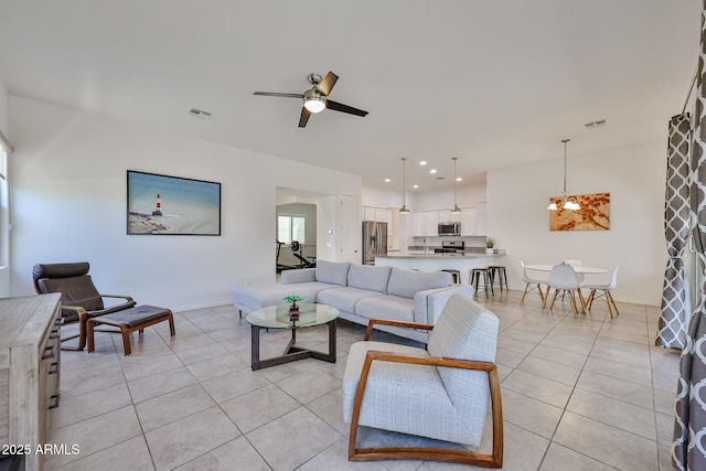 17082 S 182nd Ave, Goodyear, AZ 85338 - living room with light tile patterned floors, a ceiling fan, a chandelier, and recessed lighting