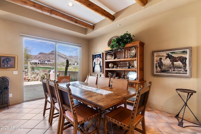 tiled dining space with a mountain view and beam ceiling